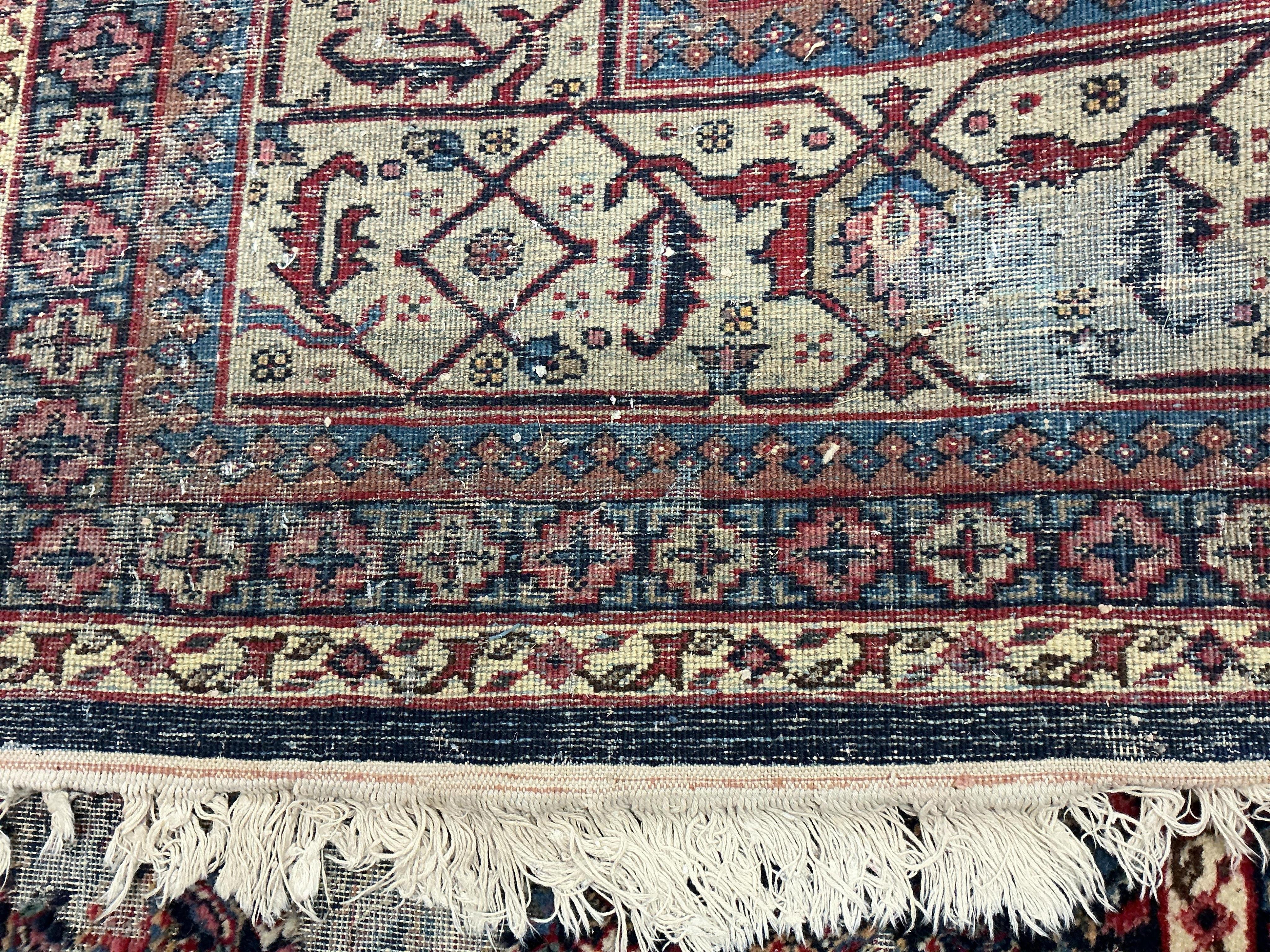 An early 20th century Tabriz blue ground floral carpet, moth damage, 440 x 340cm